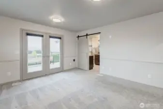 Primary suite with double doors to the back viewing deck