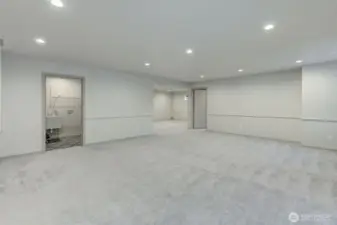 Laundry with utility sink, 4th bed to the right and more living space ahead