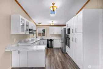 The recently updated kitchen invites you with bright white cabinets and sklights