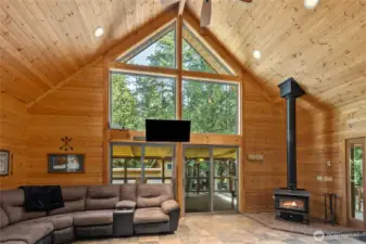 Gorgeous great room with toasty free standing wood stove, floor to ceiling windows.