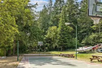 Community sports Court! You can find a game of pickleball, tennis or cornhole here!