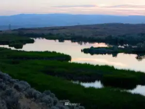 60 acres of lakes and ponds altogether:  Hilltop Lake (30 acres) spills over the 400 ft. high basalt cliff into a water fall.  Caliche Creek tumbles down alongside the Old Covered Wagon trail into the Coulee.
