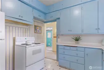 Plenty of storage in these pretty blue cabinets.