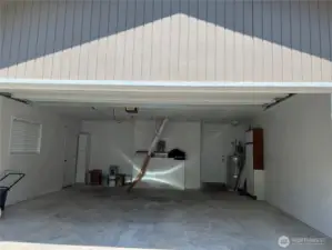 View of garage from driveway  with open door.