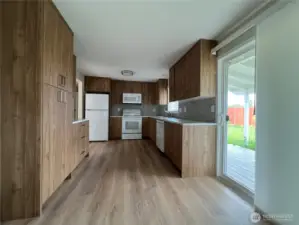 The eat-in kitchen has a sliding glass double door.