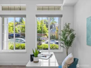 With bright windows, custom blinds & view of the neighborhood!