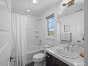 Secondary bathroom with tub.