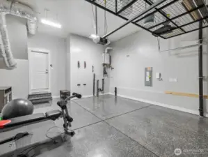 2-car garage has professionally epoxy floor. Perfect for home gym too! Note the extra storage above.