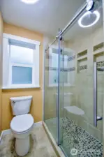 Pirmary 3/4 bath with tile floor that is heated.