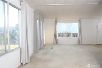 The dining room transitions smoothly into the spacious living area, enhancing the open-concept layout and natural light.