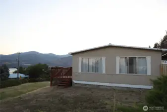 Scenic view overlooking the front yard with breathtaking vistas of Lake Chelan and the surrounding vineyards.
