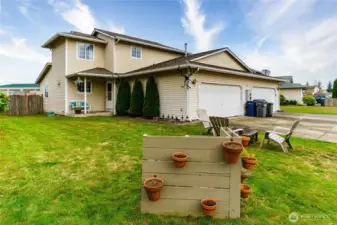 Large side yard with fenced backyard. The over sized 2-car garage has great storage!