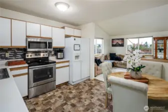 The kitchen has white cabinetry and is open to the family room making entertaining easy.