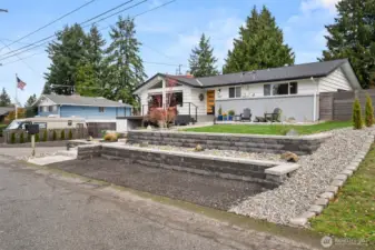 Another view of this mid-century stunner with the upgrades you love! Terraced front yard with sprinkler system for easy care; creates added off-street parking, too!