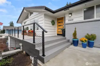 tylish covered front porch invites guests to step out of the rain.