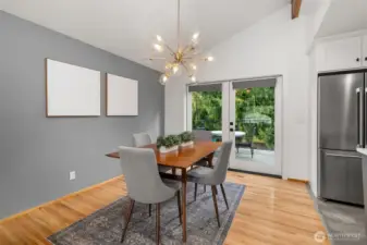 Pretty dining room helps connect guests to the chef - room for a crowd here, too - how big is your table? French doors were added to access the new huge deck; now you have indoor and al fresco dining options!