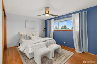 Serene main floor primary - with original hardwoods and those mid-century windows that invite you to watch the stars while you drift off to sleep.