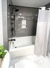 A peek at the beautiful tiled tub surround and new plumbing fixtures.