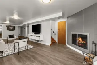 At the base of the stairs you'll find a HUGE recreation/game room, with the 2nd original fireplace. The door to the right of the stairs leads to the 400 sf carport, which is enclosed on 3 sides and has locking storage also.