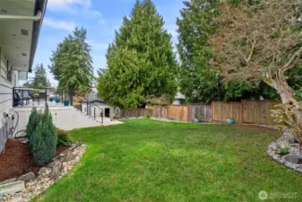 Looking back toward the deck, patios and pool shed - ample natural lawn here, too. When you tour, DON'T miss the dry storage space accessed from this side, under the deck! There is SO much storage here.