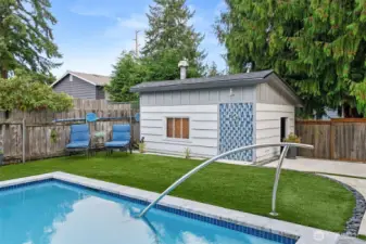 Pool shed offers ample additional storage - at the right end of the building is a fun, tiled outdoor shower!