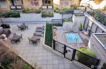 Amenities include BBQs, seating, and a spa.