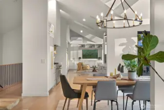 The formal dining room, bathed in abundant natural light, flows seamlessly into the kitchen, where custom cabinetry elevates both style and functionality. This harmonious connection makes it ideal for entertaining or enjoying everyday moments, with a layout that encourages togetherness and ease.
