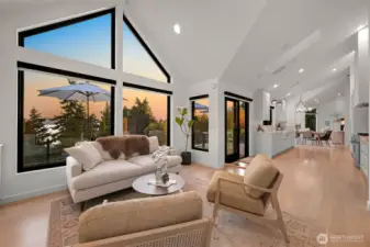 The home’s design seamlessly connects indoor and outdoor living, with walls of windows and door from both the lounge/kitchen area.