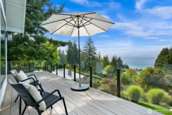 A seamless transition to outdoor living includes an Ipe deck that invites you to lounge in the sun or host unforgettable gatherings surrounded by nature’s beauty.