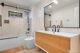 The full bath on this level is a true highlight, boasting heated tile floors for ultimate comfort and a luxurious tile-surround bathtub that transforms everyday routines into spa-like escapes.