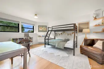 A standout feature on this level is the spacious, light-filled third bedroom. Bright and airy, it offers endless possibilities, whether as a welcoming guest room or a haven for a family member.