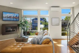 A wall of windows, in-floor heating, and a modern fireplace create the perfect setting to stay cozy as fall settles in.