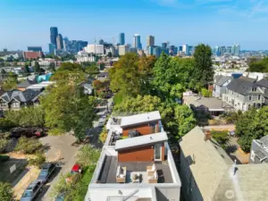 Framed by greenery, downtown rises in the distance—urban energy meets neighborhood charm.