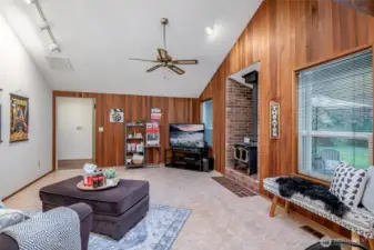 Wood burning stove, rustic paneling, easy clean floors- bring on the praty vibes!