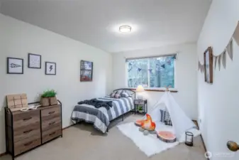 Bedroom 2 end of the hall with sprawling views of the lush backyard
