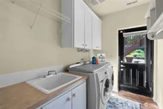 Lower-level laundry room with door to covered patio
