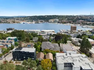 Aerial view, house in the foreground, looking east to Lake Union and the Cascade Mountains in the distance.