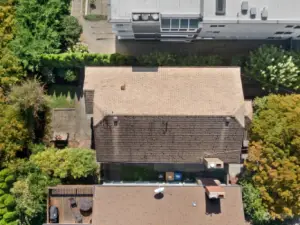 Aerial view looking straight down at the property (center of image), showing the backyard patio.