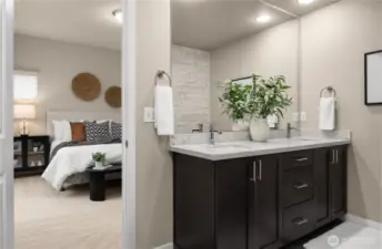 Primary bedroom with walk in bathroom that has a double vanity