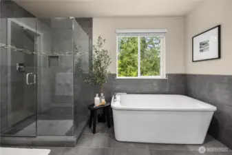 Primary bathroom with soaking tub, seamless glass shower and upgraded shower niche for shampoo.