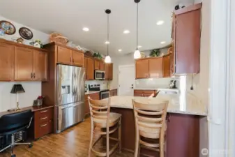 Eating bar in kitchen with also  showing desk/office area