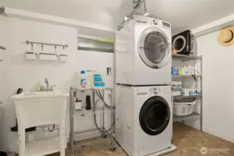 The large laundry room is off the garage. This makes it ideal for use by the main house, the DADU and the lower level if you set is up as a MIL. Each unit can access the laundry without going through another unit.