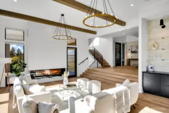The living room features a gas fireplace, wet bar, automated window shades and gorgeous designer accents.