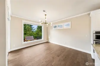 Dining area off the kitchen with large window looking out to the backyard.