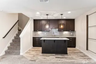 Wet bar/kitchenette with sink, wine fridge, and tons of storage!