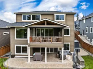 Enjoy all the space out back. Stairs to the right lead to the the side entrance to the garage and a gate to the front yard. Garden beds on this side as well.