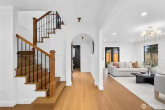 The foyer showcases this remarkably well-designed home... engineered hardwood floors abound; tasteful lighting and high-end finishes throughout with tons of special features!