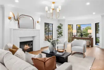 Very spacious living room with a view towards the Puget Sound; a very snazzy stone electric fireplace and stylish gold lighting fixtures...