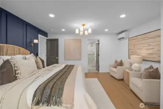 Primary bedroom en suite! This special retreat easily fits a king size bed (featured here) and sitting area. Complete with a walk-in closet and closet organizers.