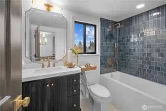 Another luxurious bath - this full bath is on the upper level featuring a designer double sink, premium tile and gold-accented designer fixtures...